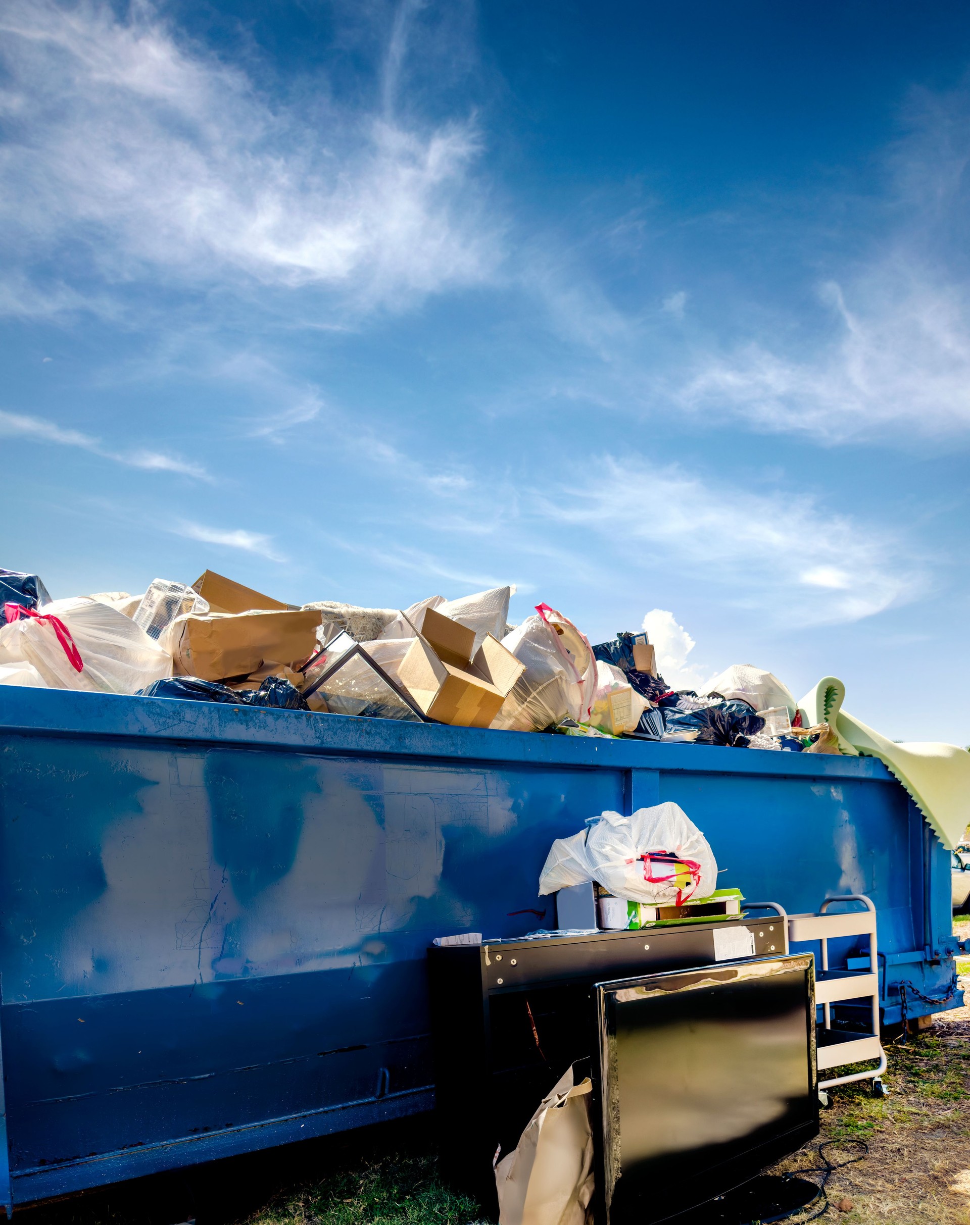 Dumpster full of trash at garbage dump area